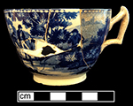 Pearlware Canova shape handled cup printed underglaze in medium blue. One of two matching cups from this assemblage. 3.5” rim diameter; 2.25” vessel height. Middle image is cup interior. Image on right, a plate, whose pattern is called "The Footbride," is from a private collection.